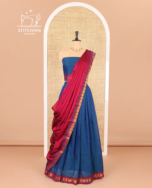 Blue half saree, plain with contrast zari peacock motifs bordered skirt, matching blouse and a contrast peacock border dhavani
