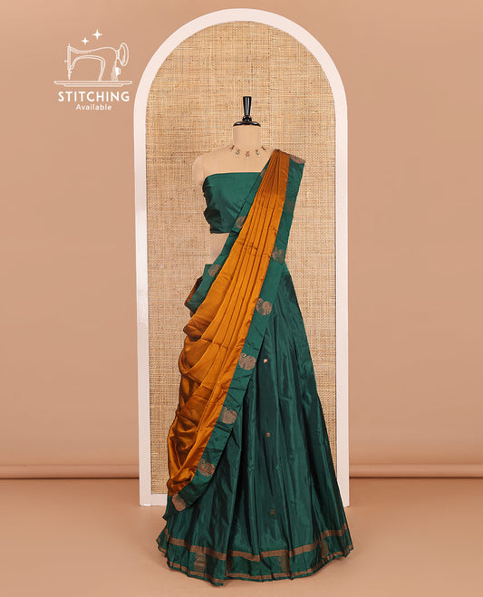 Green half-saree, buttas with self-bordered taffeta silk skirt, a plain blouse, and a contrast manga buttas bordered satin georgette dhavani