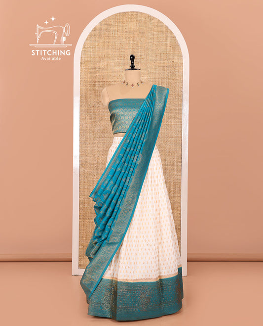 Cream and Blue Pure Georgette Crepe Half-Saree Featuring Buttas All Over Its Skirt, Complemented with Contrast Swarovski Stone Work Border, Paired with a Jacquard Blouse, and Contrast Banarasi Jacquard Dhavani