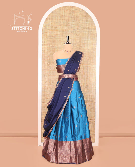 Light Blue and Navy Blue Semi-Banarasi Half-Saree, Spotlighted with Zari Buttas on Its Skirt, Complemented by a Contrast Traditional Zari Designs Woven Border, Paired with a Matching Blouse, and a Contrast Satin Georgette Embroidered Scallop Dhavani