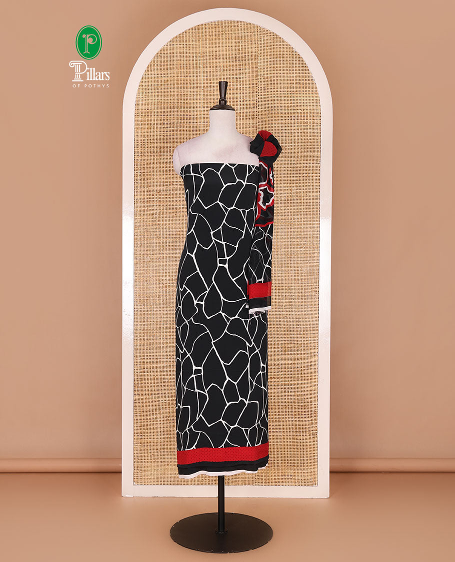 Black and white Italian crepe material churidar set, geometric printed top, plain bottom, and dupatta of floral and geometric print