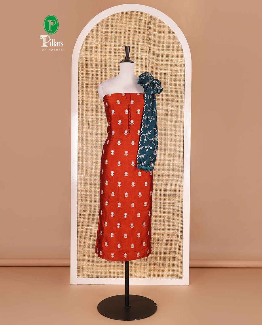 Rust Vichitra silk material churidar set, floral motifs embroidered top, contrast Santoon bottom, and floral vine thread embroidered scallop dupatta