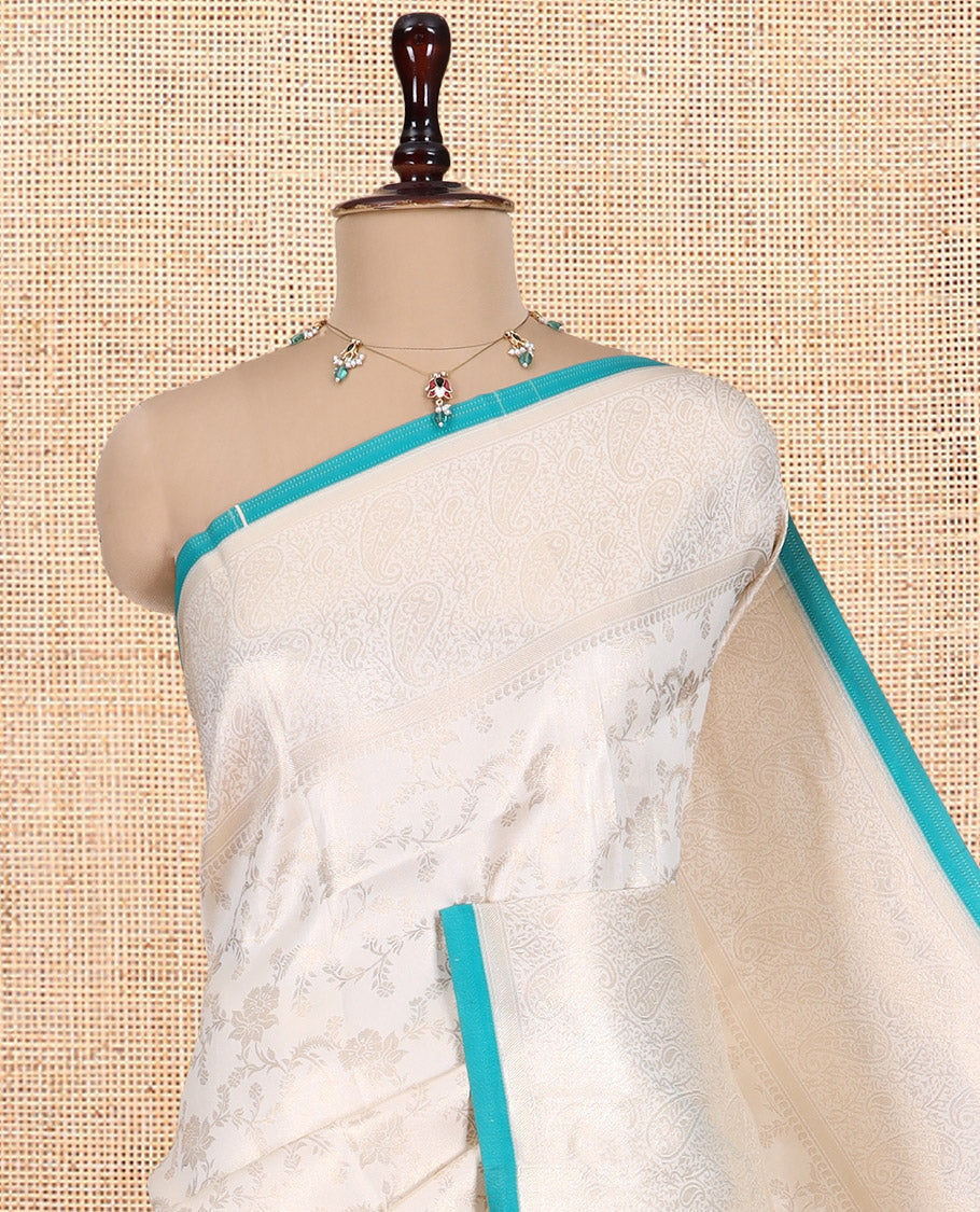 Off-White-Blue Semi-Silk Saree, Adorned with Floral Jacquard Design, a Zari Paisley Border, and a Contrast Blouse