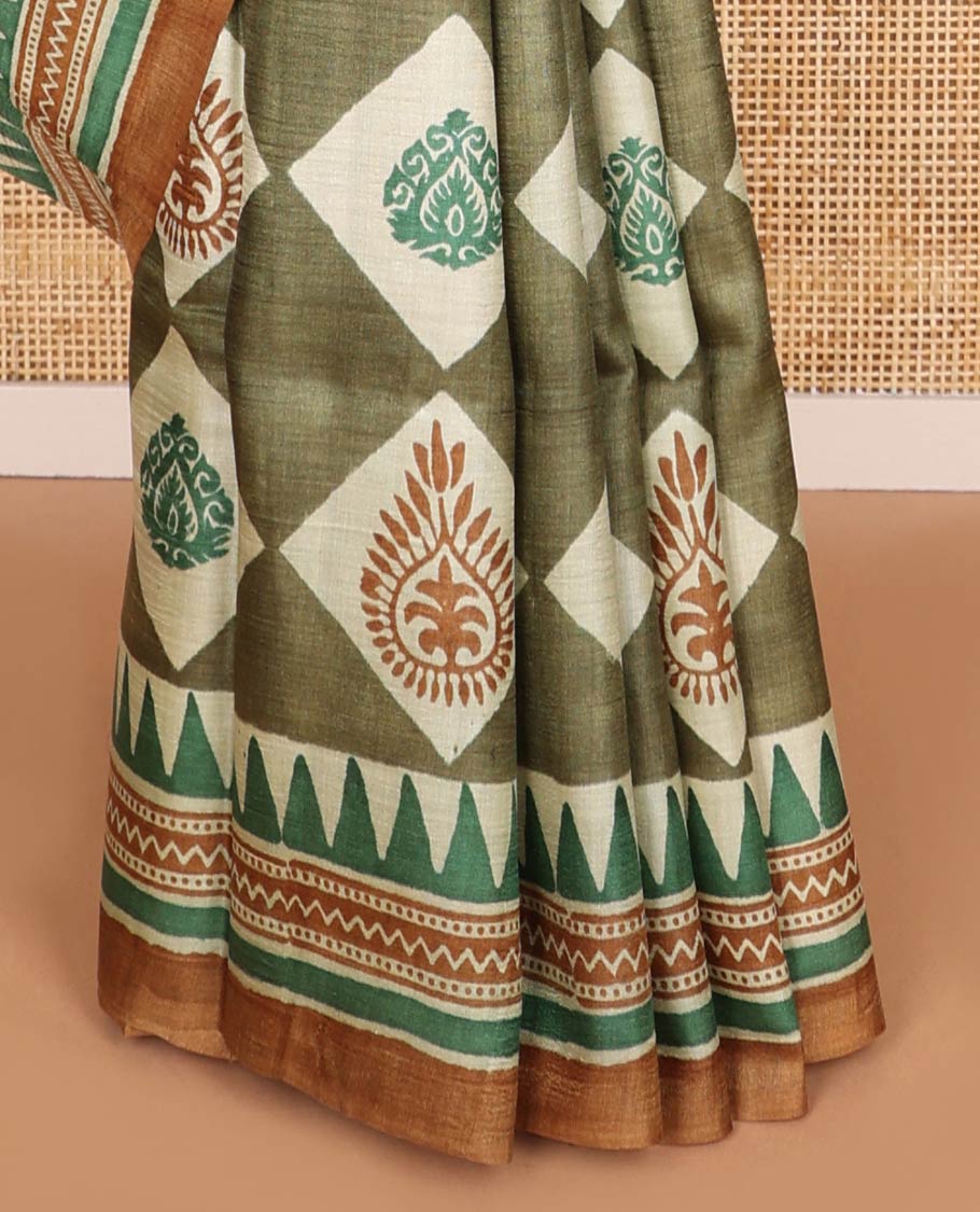 Olive green block floral print tussar saree with contrast geometric design border & floral design pallu