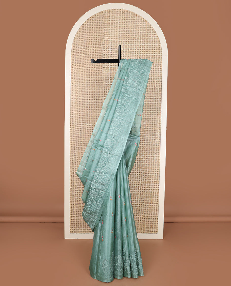 Green paisley motifs, multi-color thread embroidered tussar saree, paisley thread embroidered border, and pallu