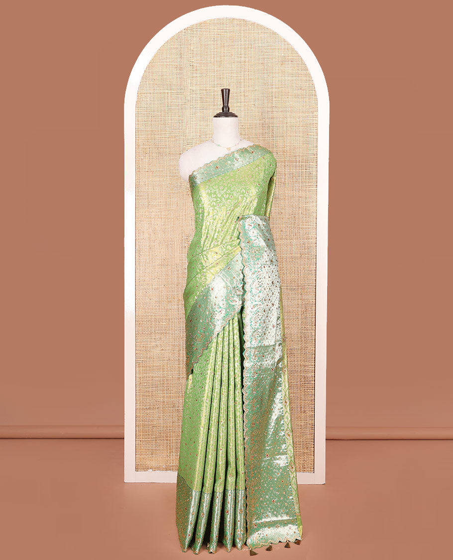 Green Vastrakala Silk Saree Highlighted with Floral Jacquard and Stone Work, Complemented by Contrast Traditional Zari and Stone Embroidered Scallop Border, Pallu Features Jaal Design and Stone Work, and Paired with Contrast Stone Embroidered Blouse