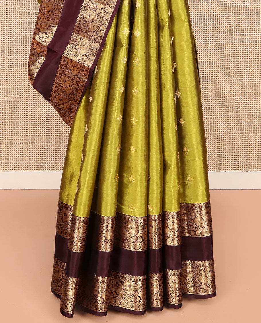 Green Vasundhara Lite Silk Mix Saree, Finely Crafted with Zari Buttas on Its Body, Complemented by Contrast Rettai Pettu Border of Mayil and Laddu Kamalam Designs, Pallu Mirrors the Same Designs, and Paired with a Contrast Blouse