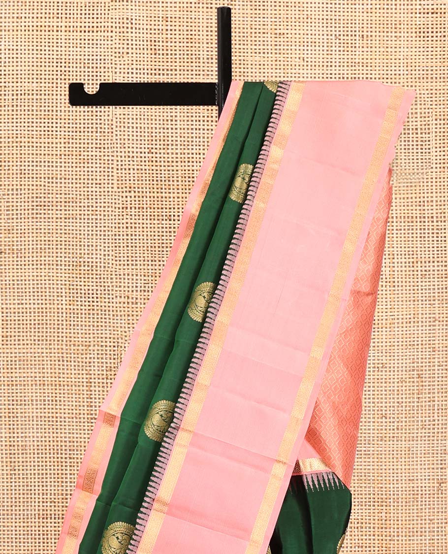 Green Vasundhara Silk Saree, Finely Crafted with Round Mayil Buttas All Over Its Body, Complemented by a Contrast Rettai Pettu Temple Border of Zari Designs, Grand Jaal Pallu, and Paired with a Contrast Blouse