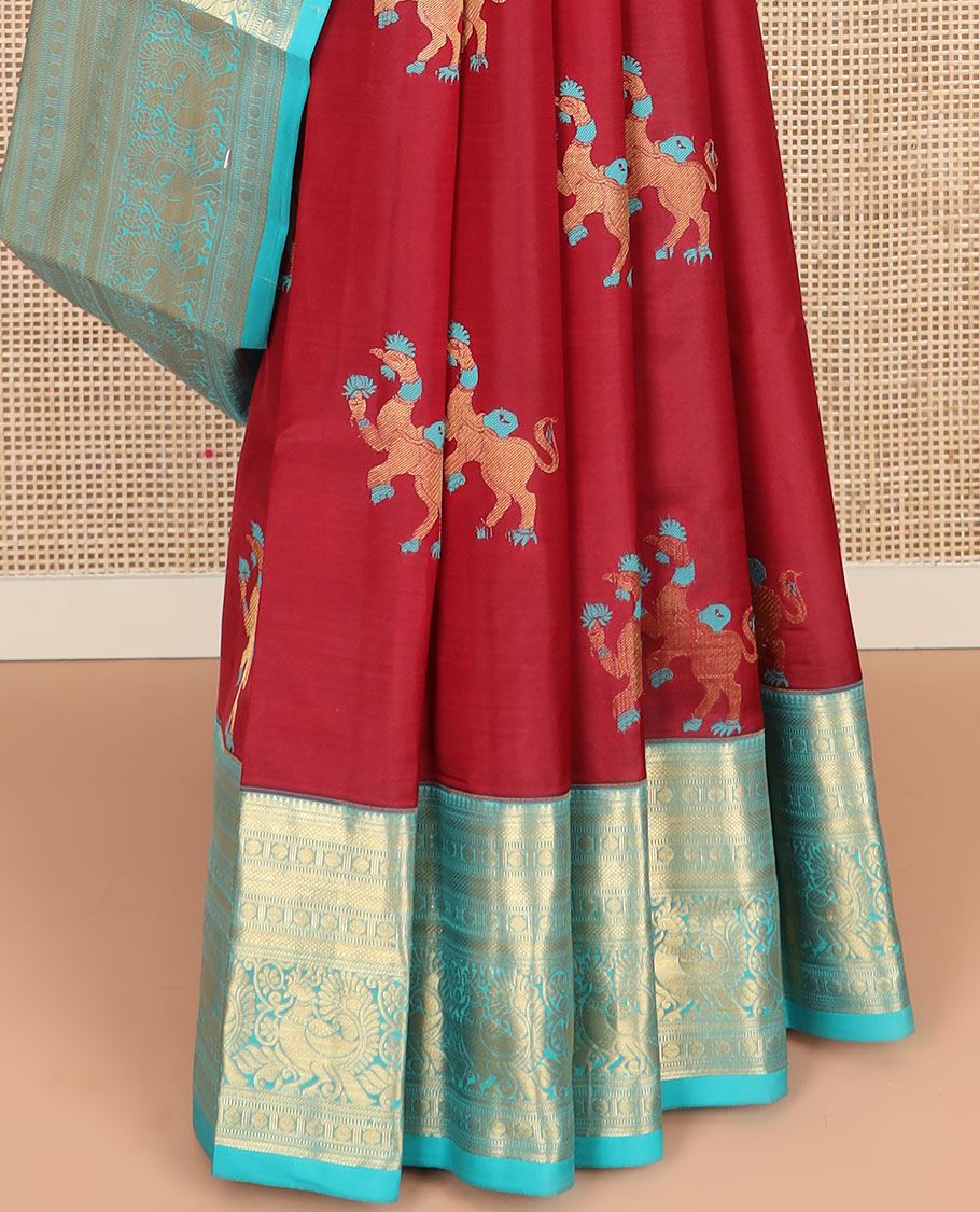 Red Vasundhara Silk Saree, Traditionally Decked up with Navagunjara Buttas, Complemented by a Contrast Border of Rekku, Kathir, Rudraksham, Muthu, and Mayil Designs, Adorned with a Pallu of Jaal Design, and Paired with a Contrast Blouse