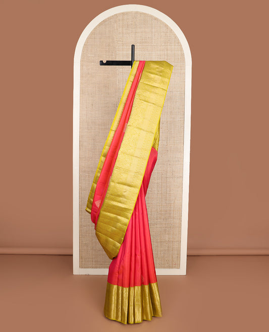 Red zari buttas silk saree, contrast border of thilakam mokku, muthu, yaali, and mayil kann, and geometric pallu