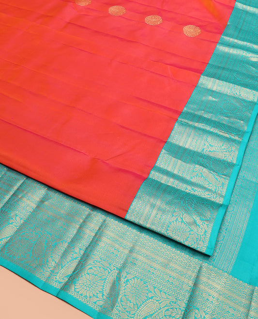 Orange Vasundhara Silk Saree Artfully Detailed with Zari Buttas, Complemented by a Contrast Border of Salngai, Neli, Kathir, and Floral-Paisley Designs, Zari-Rich Jaal Pallu, and Paired with a Contrast Zari-Bordered Blouse