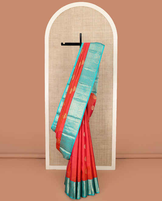 Orange Vasundhara Silk Saree Artfully Detailed with Zari Buttas, Complemented by a Contrast Border of Salngai, Neli, Kathir, and Floral-Paisley Designs, Zari-Rich Jaal Pallu, and Paired with a Contrast Zari-Bordered Blouse