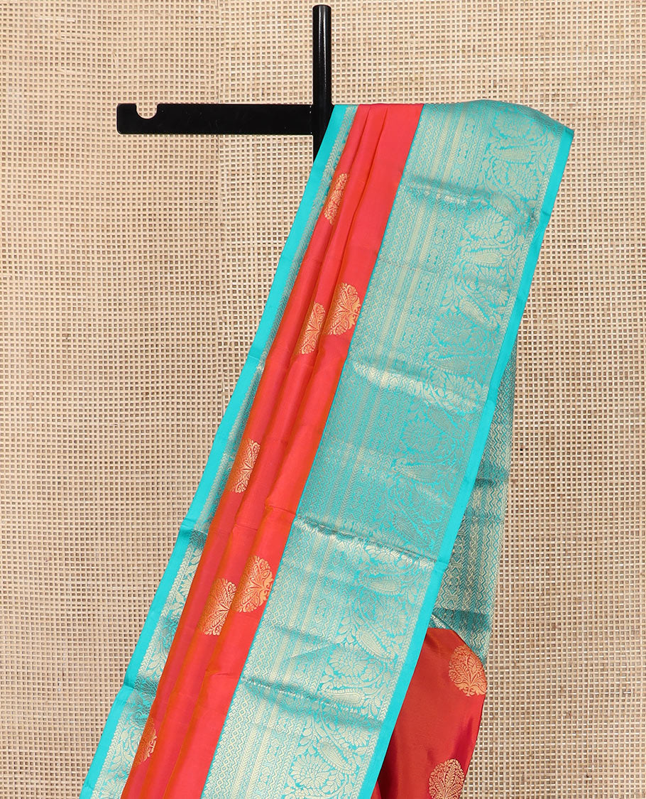 Orange Vasundhara Silk Saree Artfully Detailed with Zari Buttas, Complemented by a Contrast Border of Salngai, Neli, Kathir, and Floral-Paisley Designs, Zari-Rich Jaal Pallu, and Paired with a Contrast Zari-Bordered Blouse