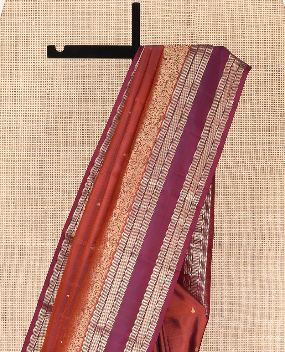 Rust Orange Vasundhara Silk Saree, Enriched with Zari Buttas All Over Its Body, Complemented by a Contrast Rettai Pettu Border of Ara Bogudi, Banaras, Muthu, and Ara Maadam Designs, Grand Jaal Pallu, and Paired with a Contrast Blouse
