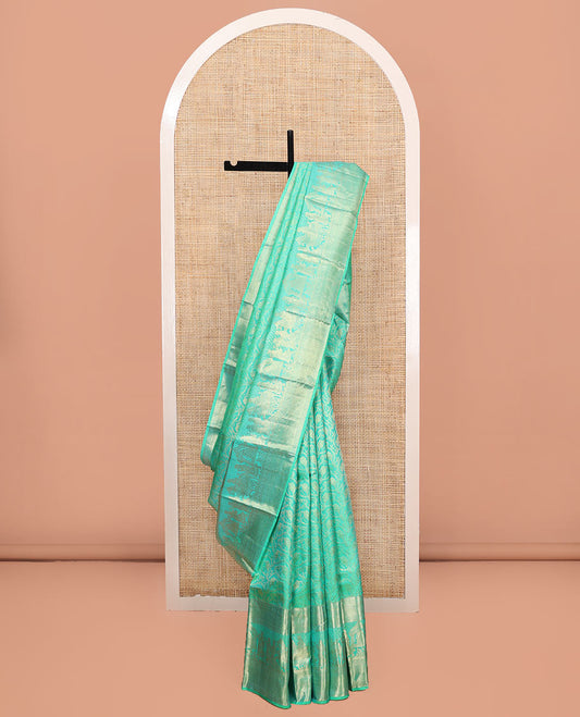 Turquoise Kanchipuram Wedding Silk Saree, Opulently Embellished with Floral Jaal Jacquard Design on Its Body, Highlighted by Zari Border of Diamond, Kuyil Kann, and Wedding-Theme Designs, Grand Jaal Pallu, and Paired with a Matching Blouse