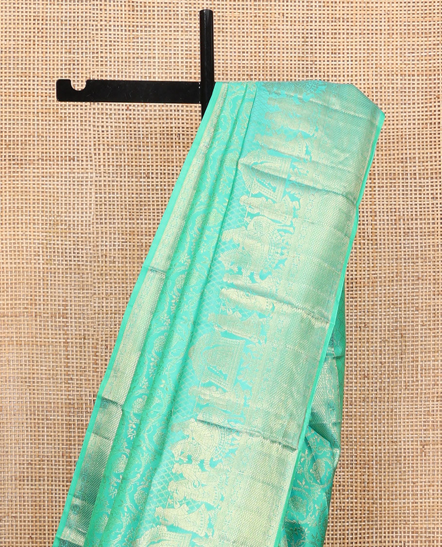 Turquoise Kanchipuram Wedding Silk Saree, Opulently Embellished with Floral Jaal Jacquard Design on Its Body, Highlighted by Zari Border of Diamond, Kuyil Kann, and Wedding-Theme Designs, Grand Jaal Pallu, and Paired with a Matching Blouse