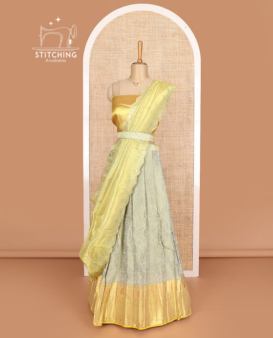 Pastel grey art silk half-saree, floral vine with contrast traditional border skirt, brocade blouse, scallop thread embroidered dhavani, and detachable belt