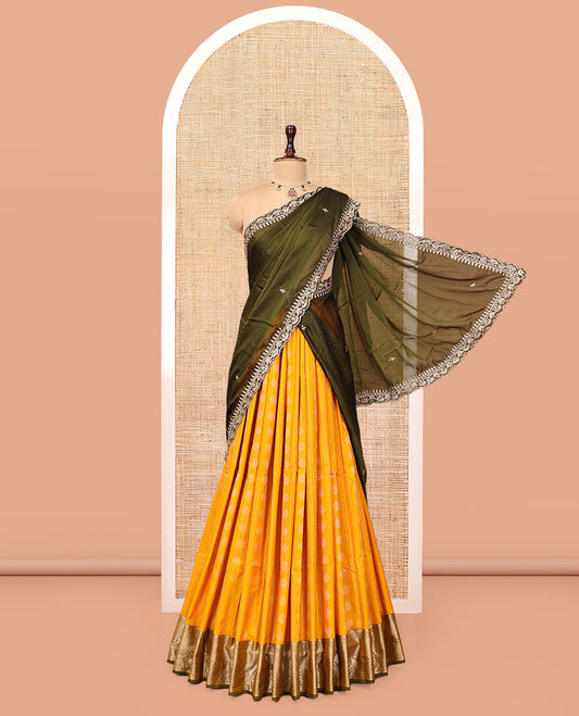 Yellow Art Silk Half-Saree Pavadai Material Features a Zari-Buttas Skirt, a Contrast Traditional Border, Contrast Blouse, and Scallop Embroidered Dhavani