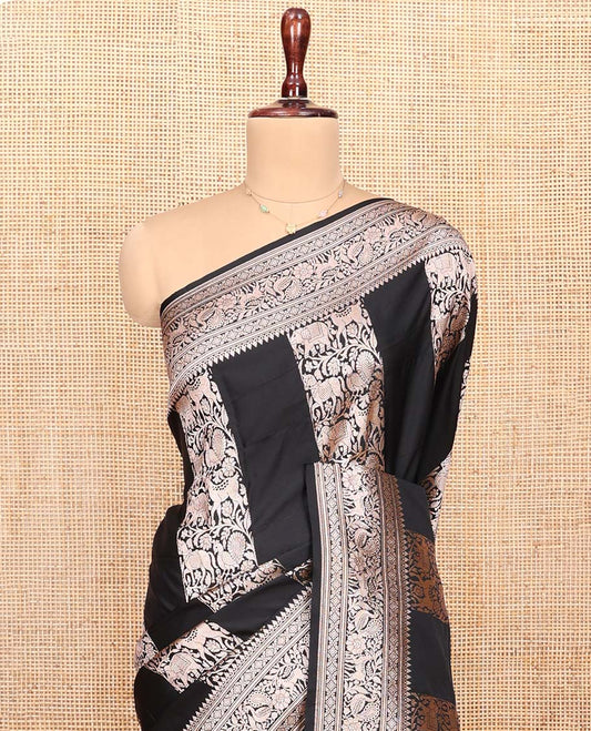 Black Semi-Banaras Silk Saree, Majestically Detailed with Animal-themed Jacquard Designs on Its Body, Highlighted by a Zari Border of Traditional Designs, Pallu Steeped with Stripes, and Paired with a Matching Blouse
