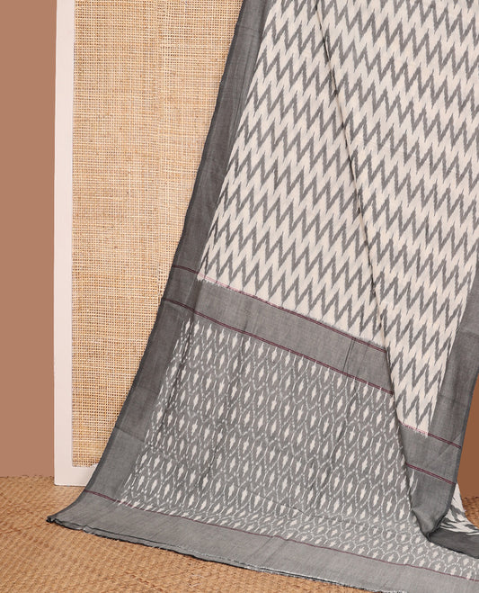 Half-white chevron striped ikkat cotton saree, contrast plain border, and ogee patterned pallu