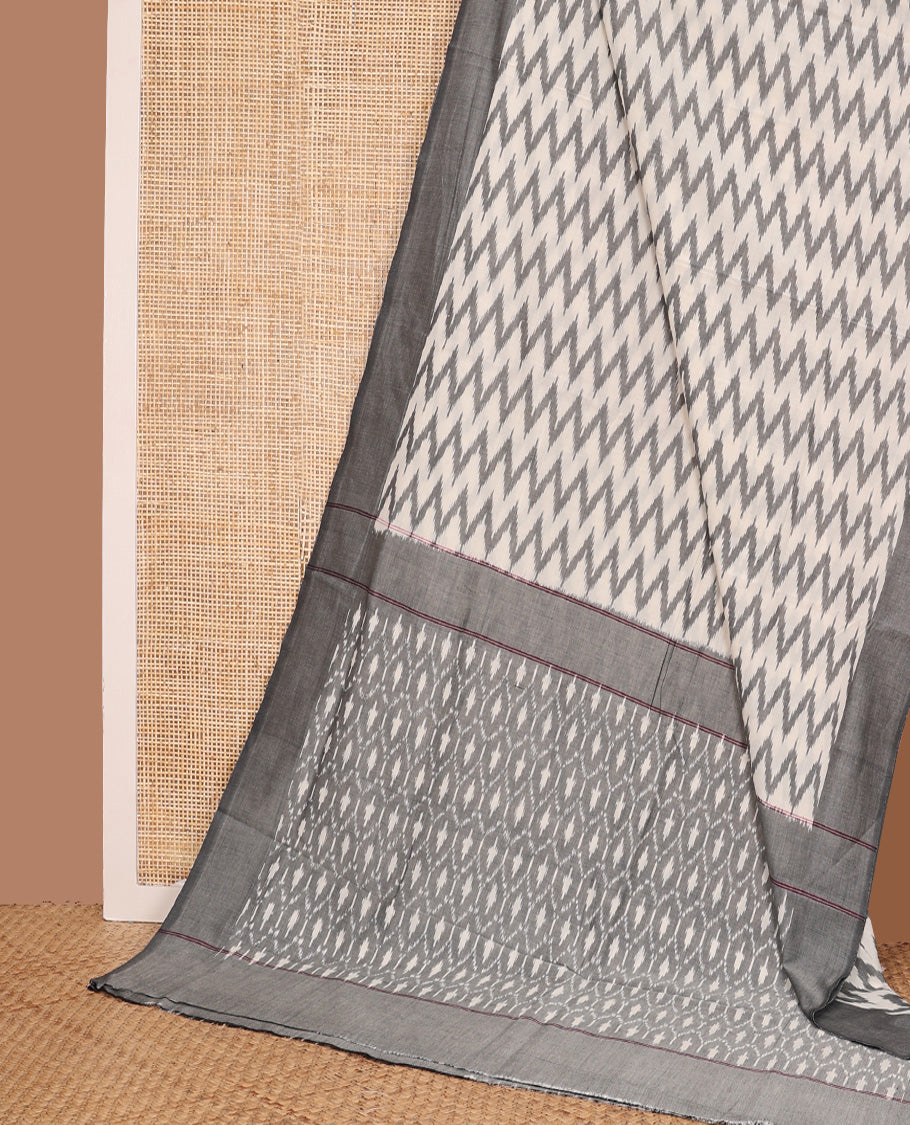 Half-white chevron striped ikkat cotton saree, contrast plain border, and ogee patterned pallu
