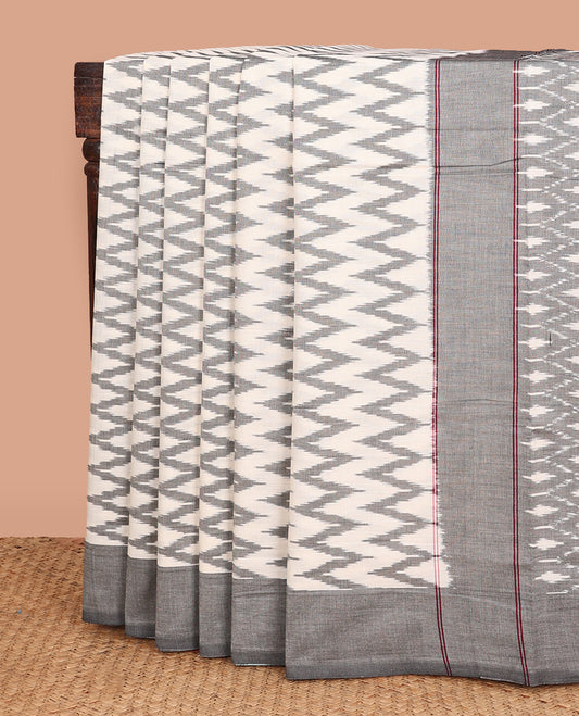 Half-white chevron striped ikkat cotton saree, contrast plain border, and ogee patterned pallu