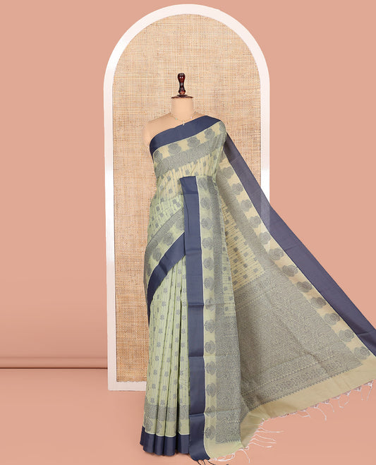 Pastel Green Semi-Silk Cotton Saree, Sparsely Woven with Floral Designs All Over Its Body, Complemented by Contrast Border, Sparsely Woven Pallu of Intricate Designs, and Paired with a Matching Blouse