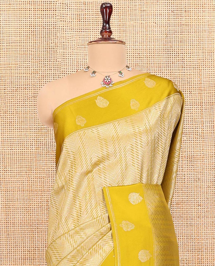 Mustard Russian Dola Silk Saree, Opulently Embellished with Zari Zig-Zag Jacquard on Its Body, Highlighted by Zari Buttas Woven Satin Border, Intricately Designed Pallu, and Paired with a Matching Blouse
