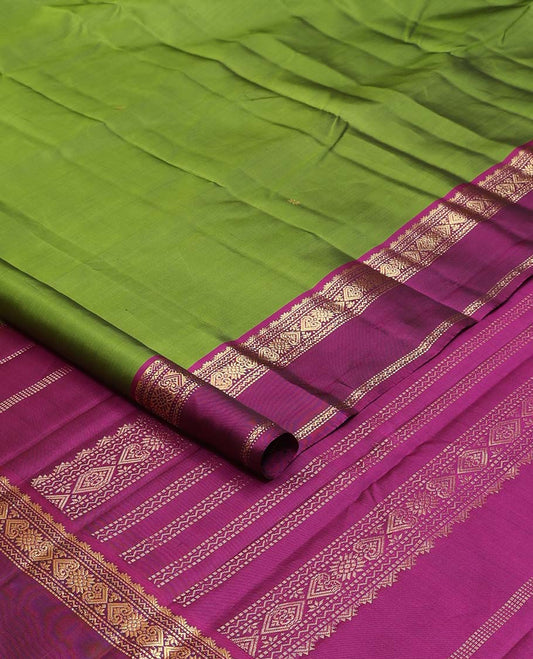 Green zari buttas Kanchipuram silk saree, contrast rettai pettu border and pallu of rekku, muthu, neli, and jadai nagam designs