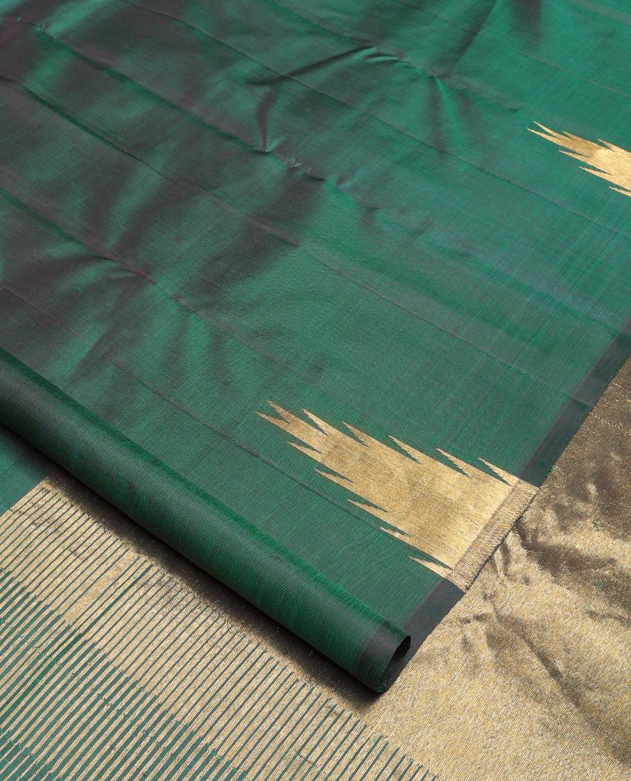 Green plain Kanchipuram silk saree, gleaming antique golden zari colored thazampoo rekku border, and zari-rich pallu of seppu rekku design