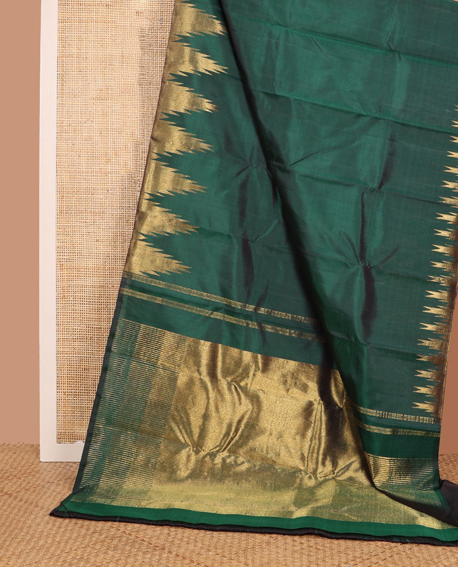 Green plain Kanchipuram silk saree, gleaming antique golden zari colored thazampoo rekku border, and zari-rich pallu of seppu rekku design