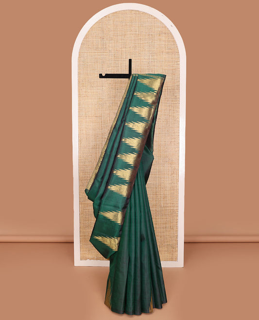 Green plain Kanchipuram silk saree, gleaming antique golden zari colored thazampoo rekku border, and zari-rich pallu of seppu rekku design
