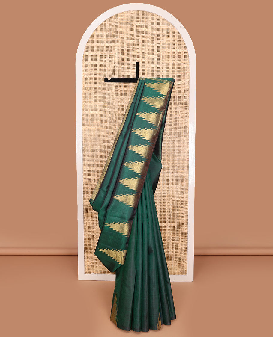 Green plain Kanchipuram silk saree, gleaming antique golden zari colored thazampoo rekku border, and zari-rich pallu of seppu rekku design