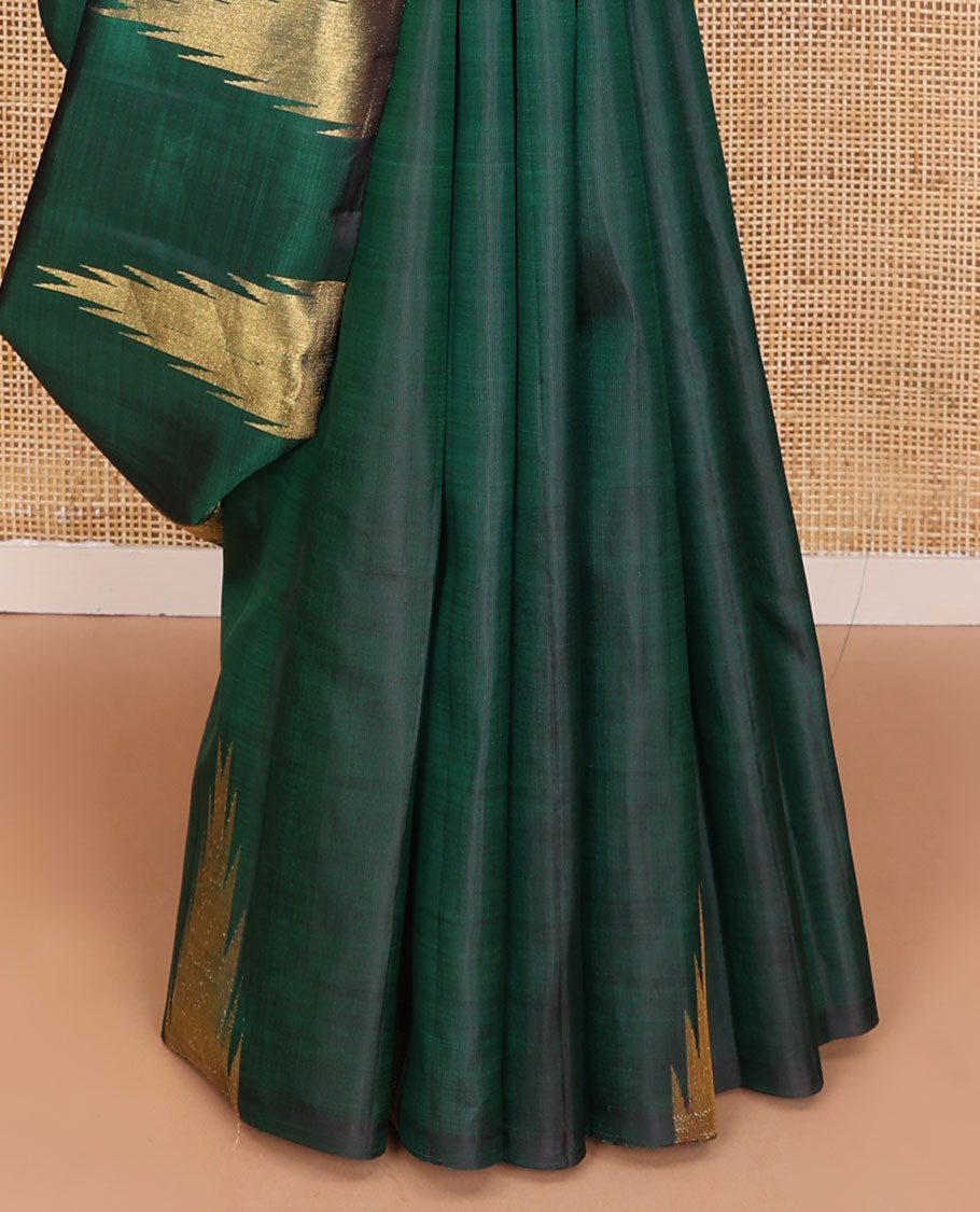 Green plain Kanchipuram silk saree, gleaming antique golden zari colored thazampoo rekku border, and zari-rich pallu of seppu rekku design