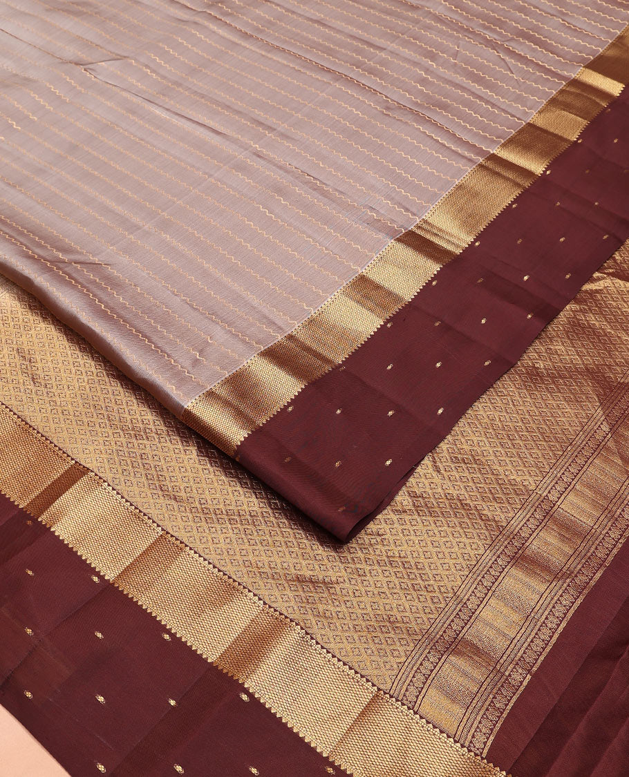 Grey Vasundhara Lite-Silk Mix Saree Enriched with Zig-Zag Zari Stripes, Complemented with a Contrast Border Featuring Rekku, Muthu, and Mayil Kann Design, Opulently Embellished Pallu of Jaal Design, and a Contrast Blouse
