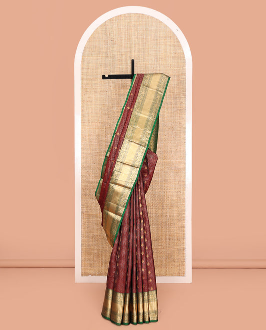Brown Vasundhara Lite Silk Mix Saree, Meticulously Crafted with Zari Buttas and Checks On Its Body, Complemented by Contrast Border of Thilakam Mokku, Muthu, Banaras, Mayil, and Mayil Kann Designs, Grandly Decked Up Pallu and Paired with a Contrast Blouse