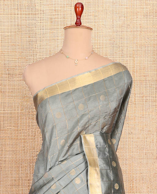 Grey Banana Pith Saree Subtly Sparkled with Polka Dot Buttas Enclosed Checks, Subtle Zari Border, Gleaming Zari Stripes Woven Pallu, and Paired with a Matching Plain Blouse