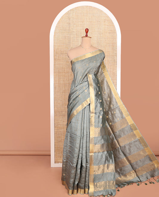 Grey Banana Pith Saree Subtly Sparkled with Polka Dot Buttas Enclosed Checks, Subtle Zari Border, Gleaming Zari Stripes Woven Pallu, and Paired with a Matching Plain Blouse