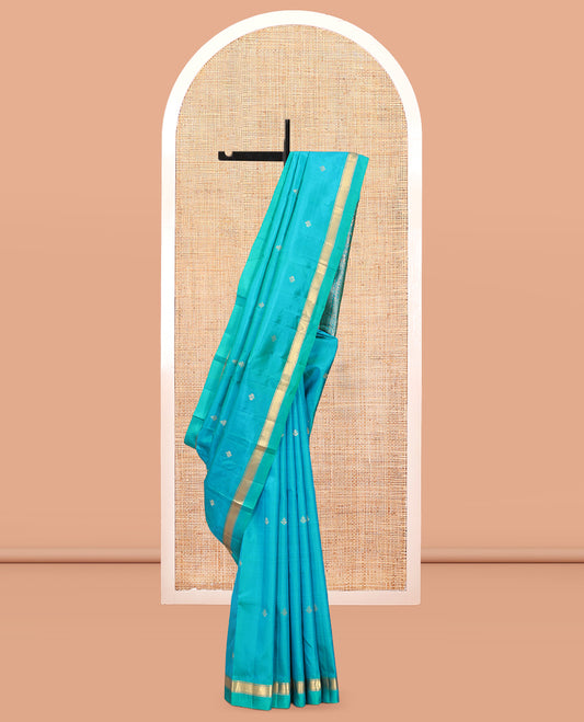 Blue Vasundhara Silk Saree, Subtly Sparkled with Zari Buttas, a Kal Eragina Border of Muthu Designs, Geometric Patterned Pallu, and a Matching Blouse