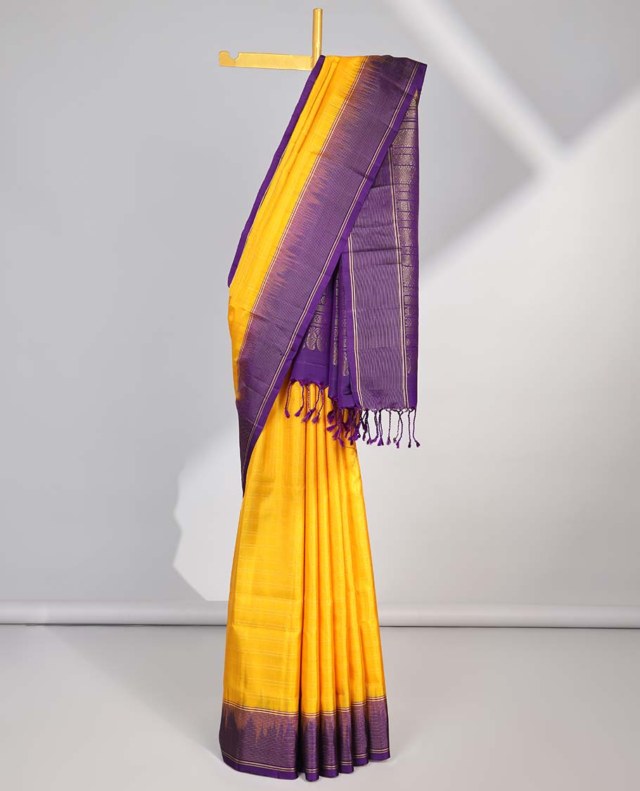 Yellow soft silk saree with contrast striped zari border & intricate zari design pallu