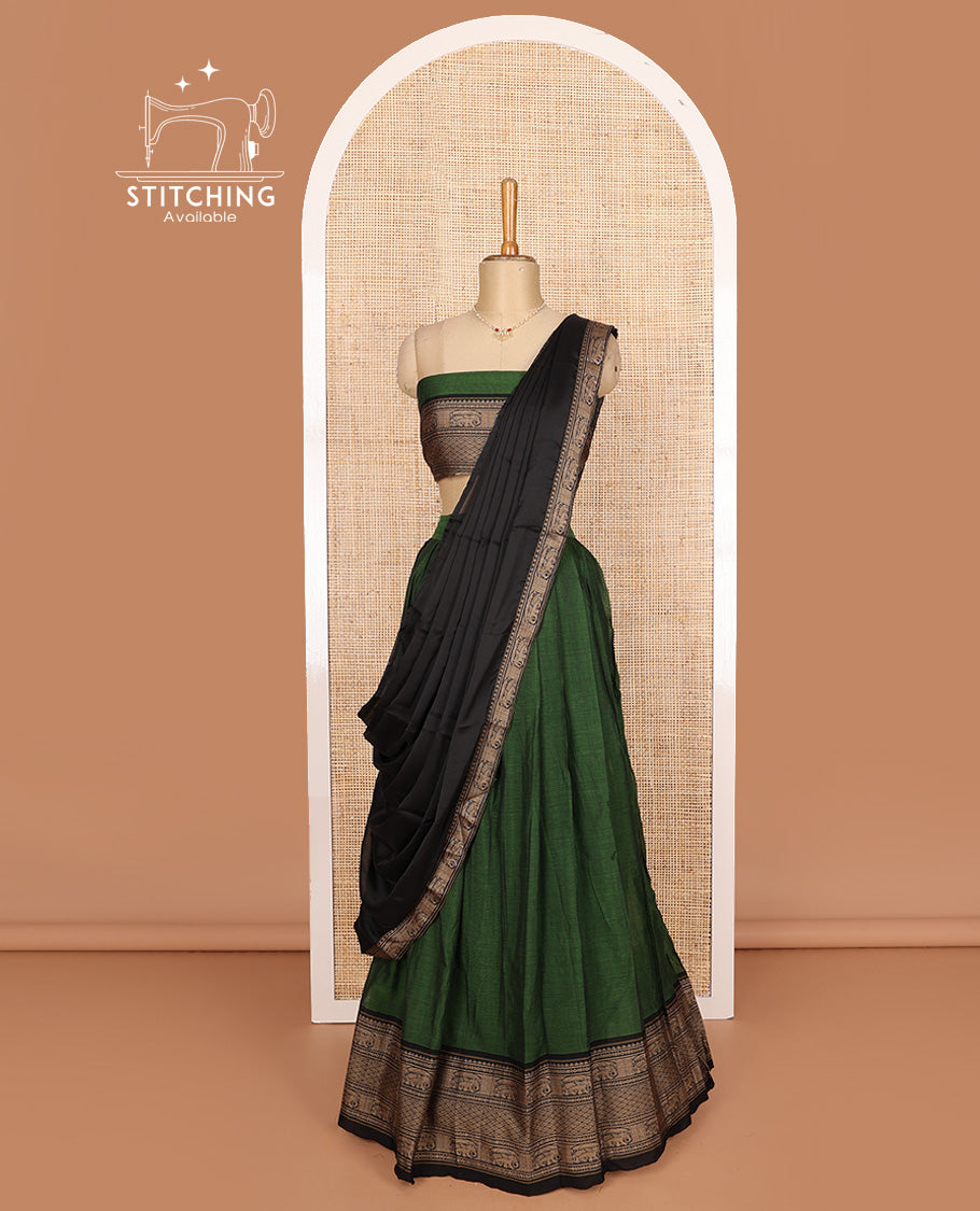 Green cotton half-saree, plain with contrast traditional motifs bordered skirt, matching blouse, and contrast elephant motif dhavani