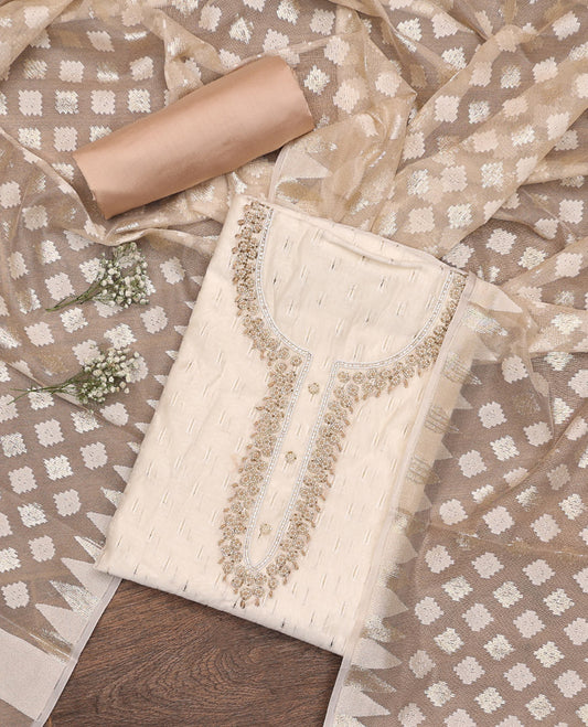 Cream Material Chudidar Set, Subtly Adorned with Sparese Buttas and Embroidery on Tissue Top, a Contrast Santoon Bottom, and Paired with Buttas Steeped Chanderi Silk Dupatta