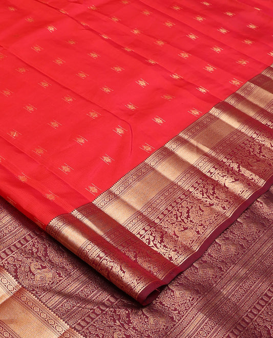 Red zari buttas Vasundhara silk mix saree, contrast border of rekku, laddu kamalam, kuyil kann, rettai neli, poun, and mayil, and intricate pallu