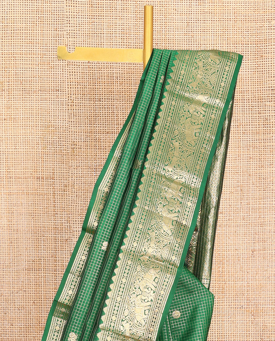 Green Vasundhara Silk Saree Gleamed Up with Zari Checks and Annam Chakram Buttas, Complemented by a Zari Border of Thazampoo Rekku, Neli, Rudraksham, Diamond and Yaanai Designs, Zari Embellished Pallu of Jaal Designs, and Paired with a Matching Blouse