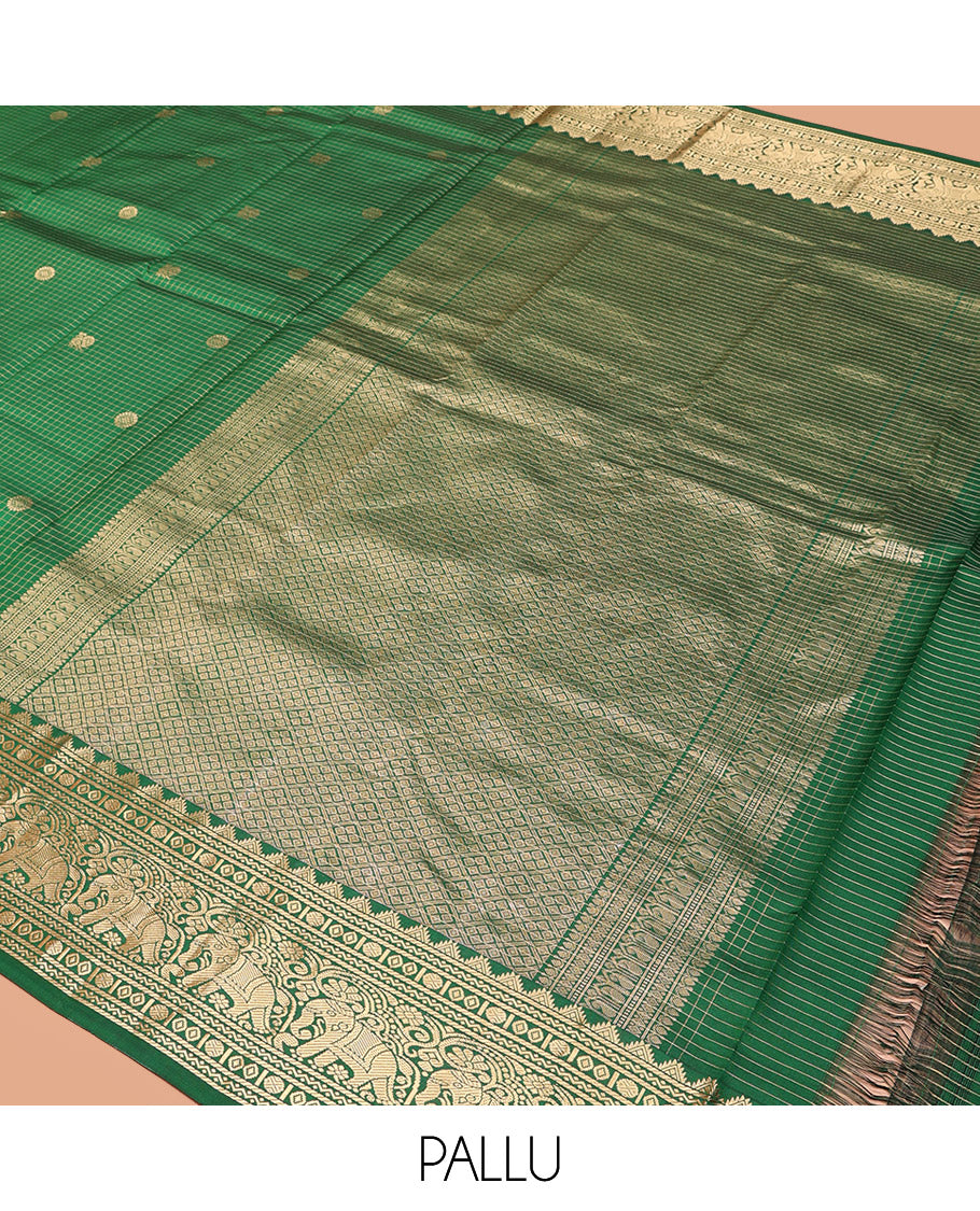 Green Vasundhara Silk Saree Gleamed Up with Zari Checks and Annam Chakram Buttas, Complemented by a Zari Border of Thazampoo Rekku, Neli, Rudraksham, Diamond and Yaanai Designs, Zari Embellished Pallu of Jaal Designs, and Paired with a Matching Blouse