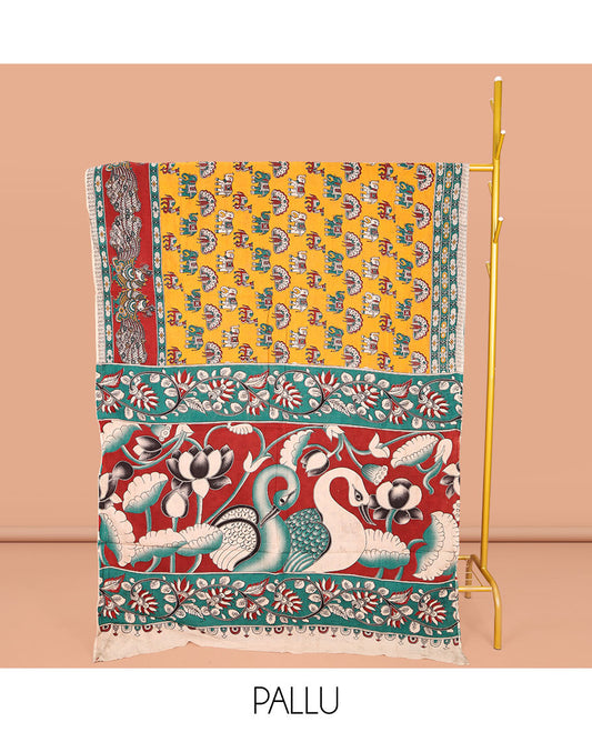 Orange Machine-Printed Kalamkari Cotton Saree, Accentuated with Peacock, Elephant, and Camel Motifs  on Its Body, Complemented by a Contrast Border of Peacock Print, Pallu of Leaf Print, and Paired with a Printed Blouse