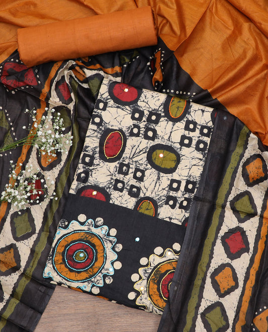 Black cotton material chudidar set, batik style geometric printed with mirror work top, contrast orange plain bottom and batik printed dupatta