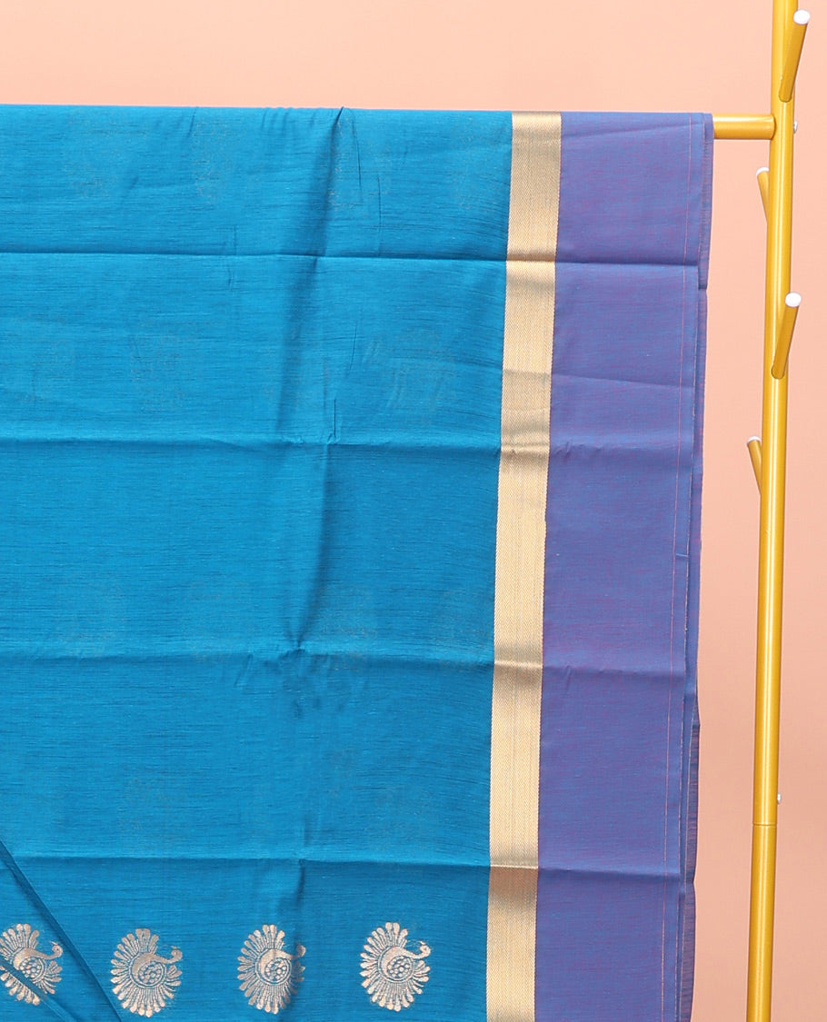 Blue Semi-Silk Cotton Saree, Gracefully Embellished with Bird Zari Buttas on Its Body, Complemented by Contrast Border of Peacock Buttas, Pallu Features Peacock Designs, and Paired with a Matching Blouse