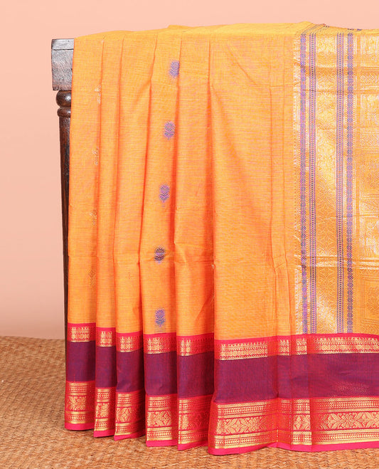 Orange Chettinad Cotton Saree Adorned with Floral Thread Buttas All Over Its Body, Complemented by Contrast Rettai Pettu Border of Traditional Designs, Pallu of Peacock and Yaali Butta Enclosed Checks, and Paired with a Matching Blouse