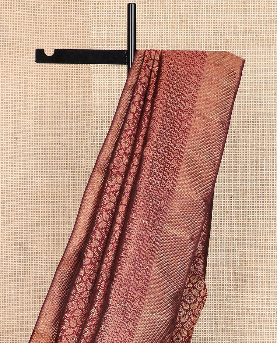 Maroon Jacquard Kanchipuram silksaree,zari border of reeku,paisa,banaras,kodi visiry,neli,manga,lavangam & mayil kann & intricate pallu